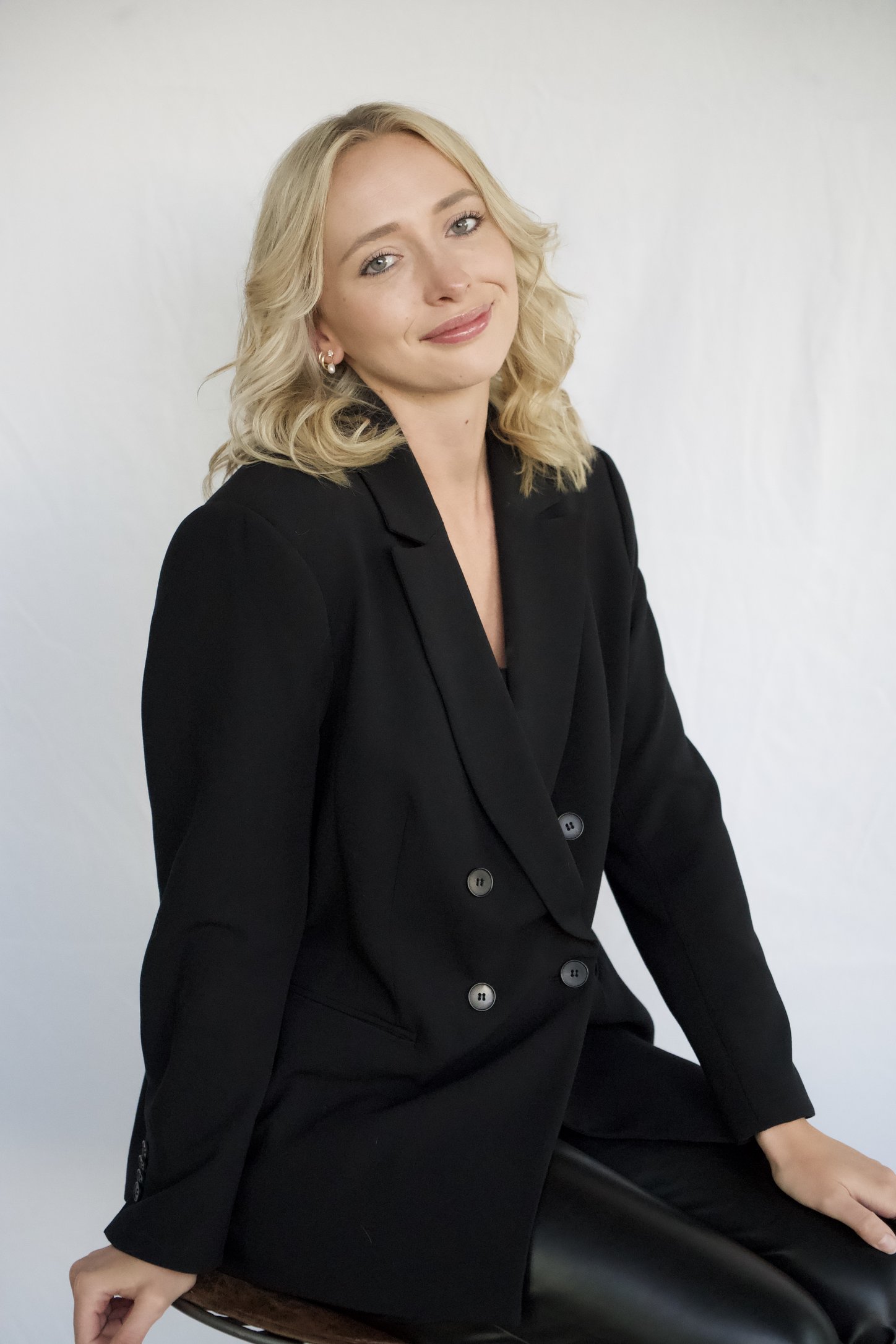 Ashley Summerfield, founder of Posie Photo Booth Co., seated