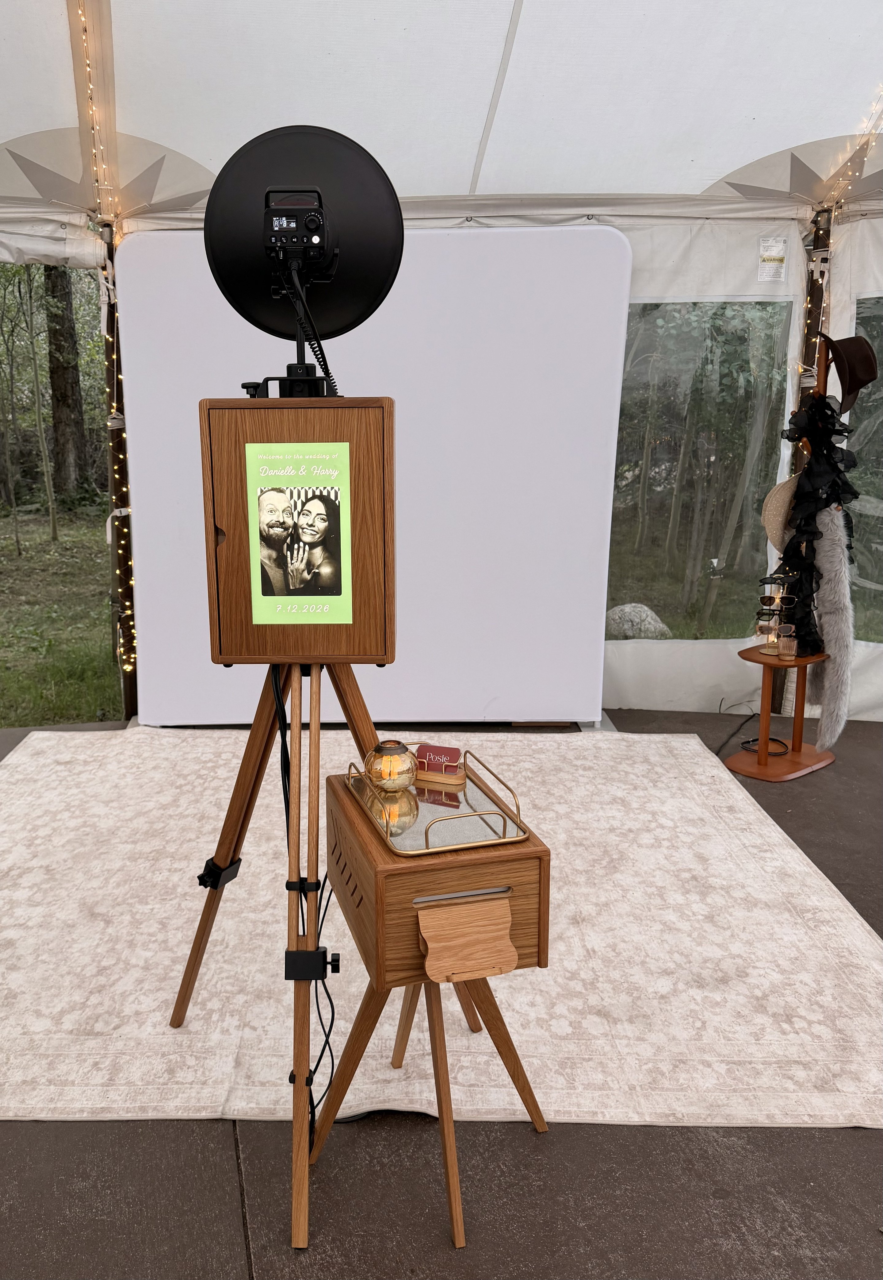 The all-wood Posie booth set up under a tent