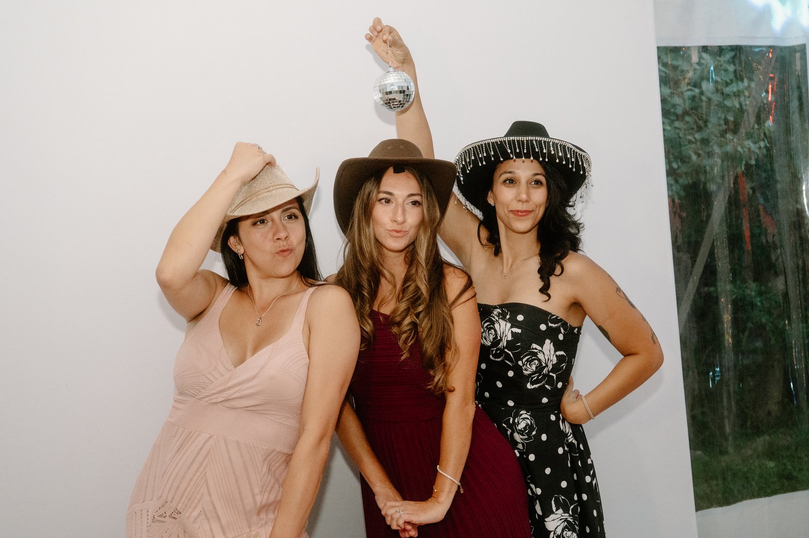 Three guests in cowboy hats posing for the booth